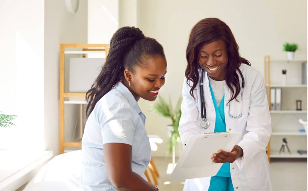 A doctor explaining Aetna rehab coverage in Michigan as the patient looks relieved.
