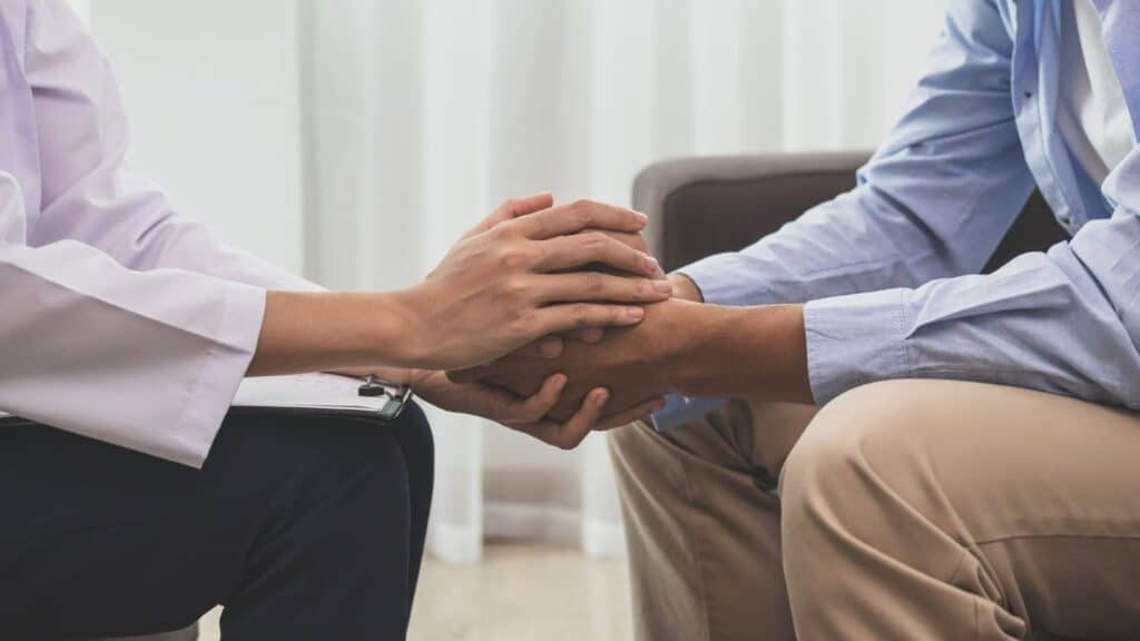A therapist offers emotional support during drug addiction treatment in Michigan.