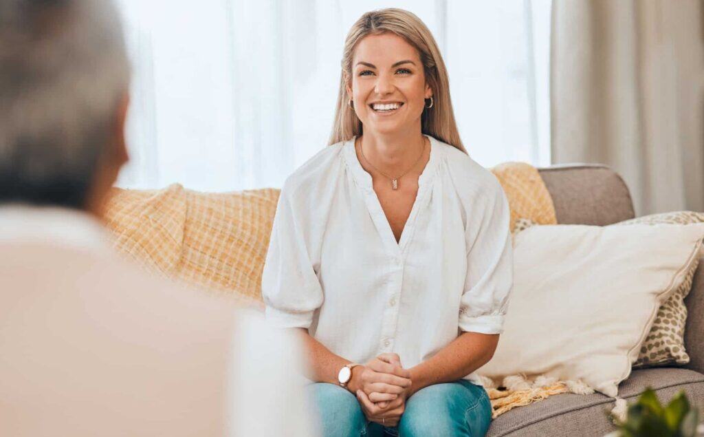 A woman smiling during a session of CBT in Michigan.