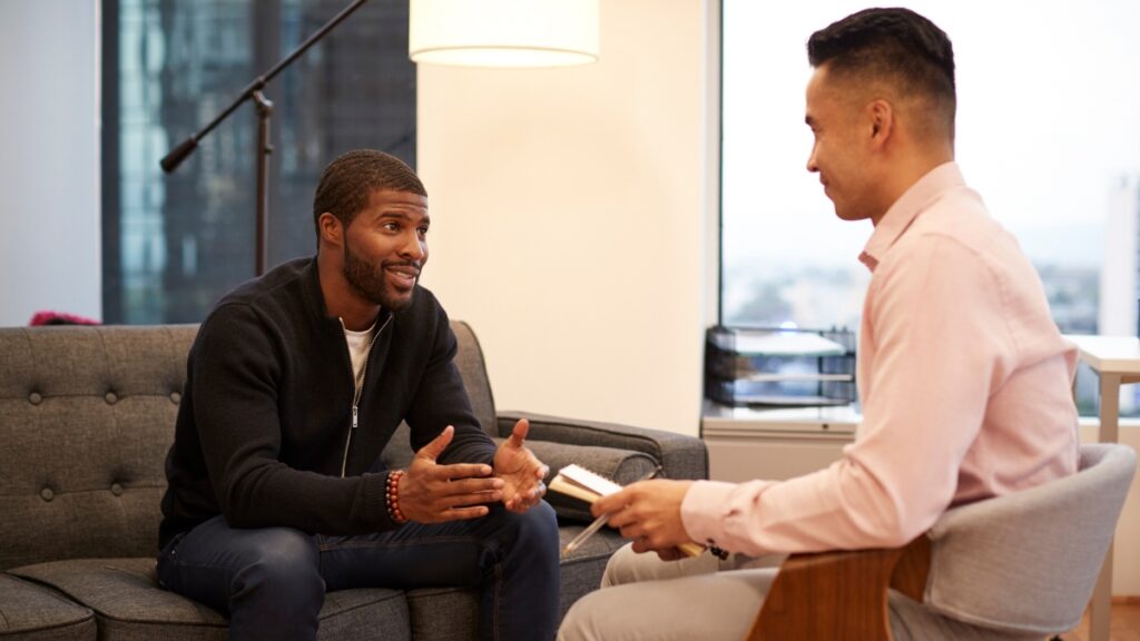 A man shares his experiences during a one on one therapy treatment session.
