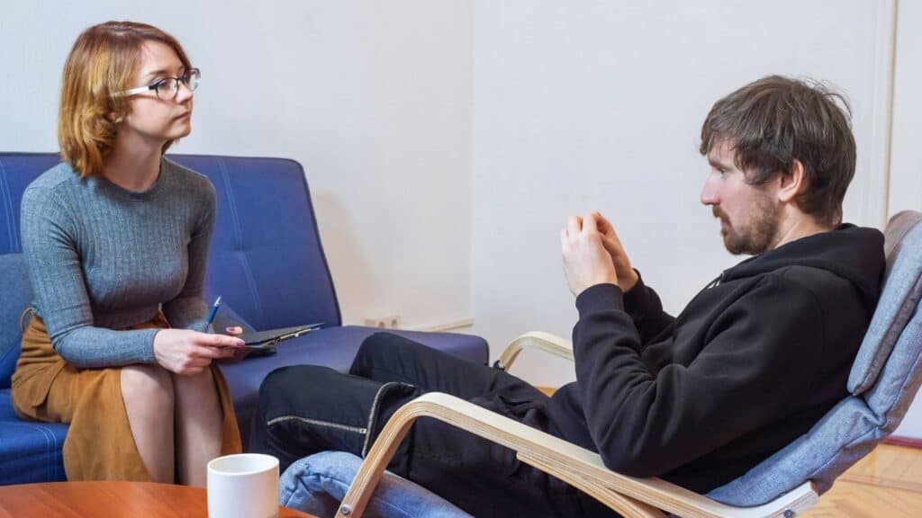 A therapist offers emotional support during co-occurring disorder treatment in Michigan.