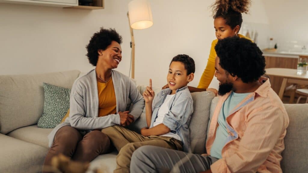 Two parents and their children enjoy family therapy in michigan