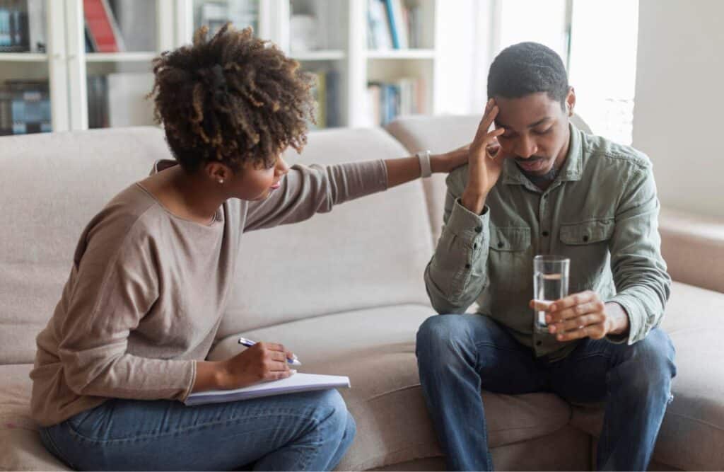 Therapist supporting a client through opioid addiction treatment in Michigan.