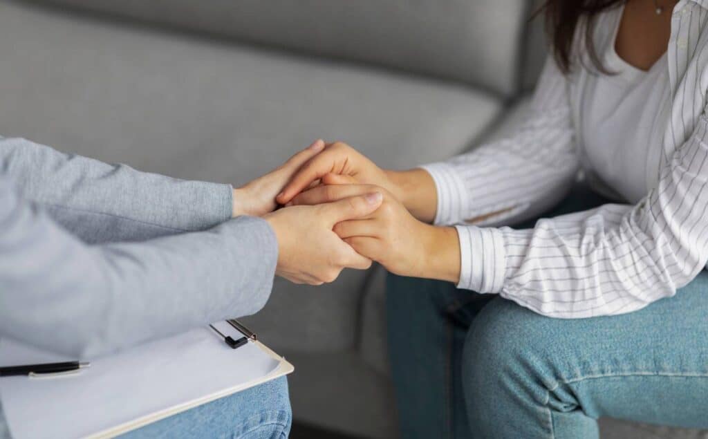 Therapist supporting client in bipolar disorder treatment in Michigan.
