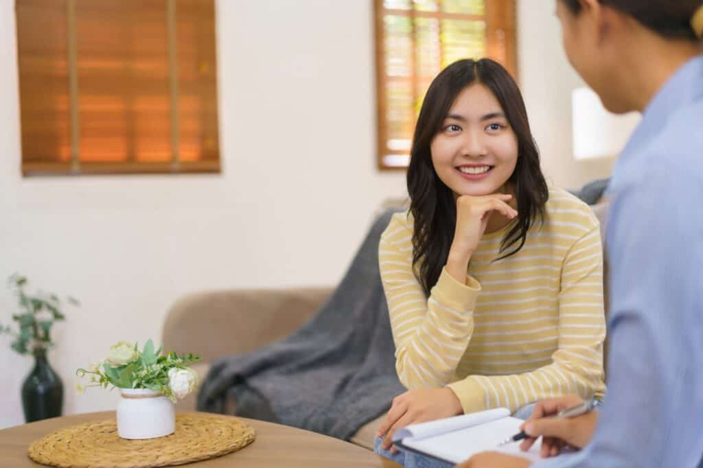 A woman enjoys personalized individual therapy during recovery treatment.