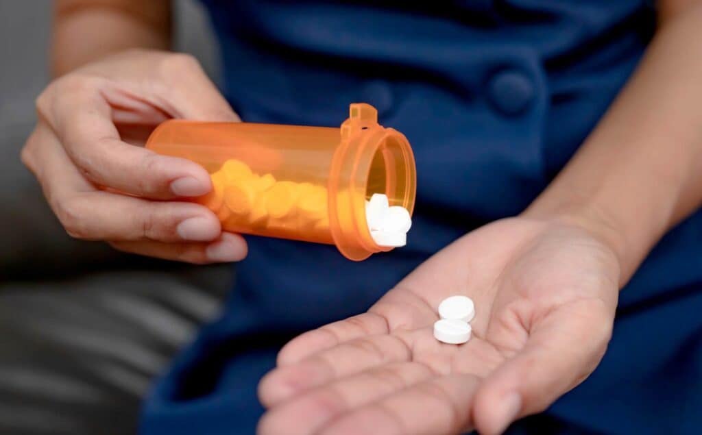 Individual misusing medication and in need of codeine addiction treatment in Michigan.