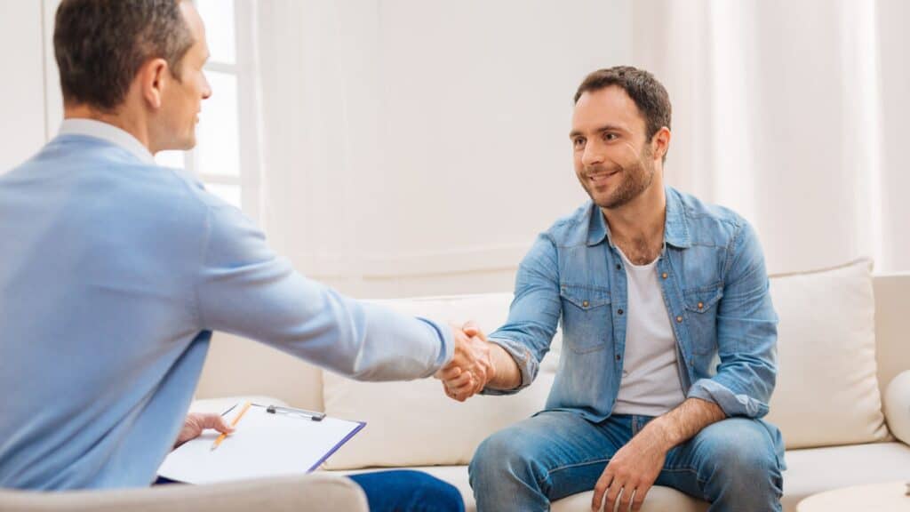 Man meeting with a specialist to review UHC rehab coverage in Michigan.