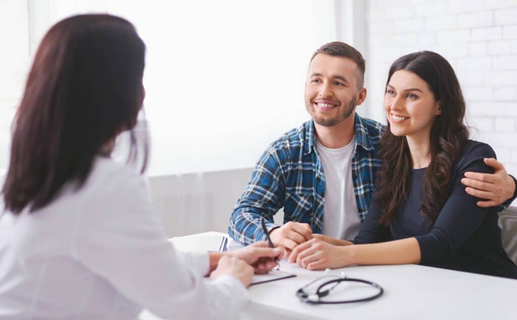 Insurance specialist discussing how insurance covers rehab in Michigan with a couple.