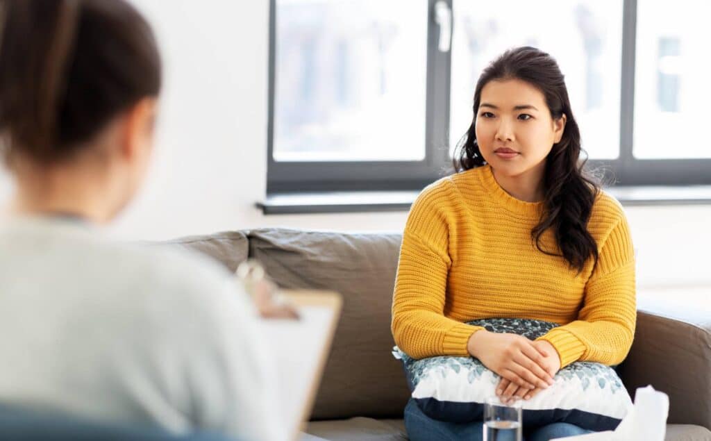 Woman speaking with therapist at a rehab serving South Bend, Indiana.