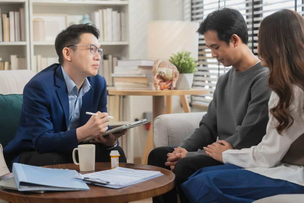 Couple participating in therapy while creating a mental health maintenance plan with a counselor at Enlightened Recovery Michigan