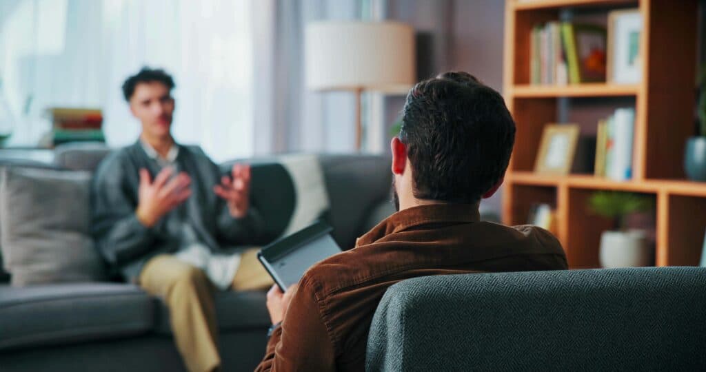 Man meeting with therapist during consultation to develop a mental health maintenance plan at Enlightened Recovery Michigan