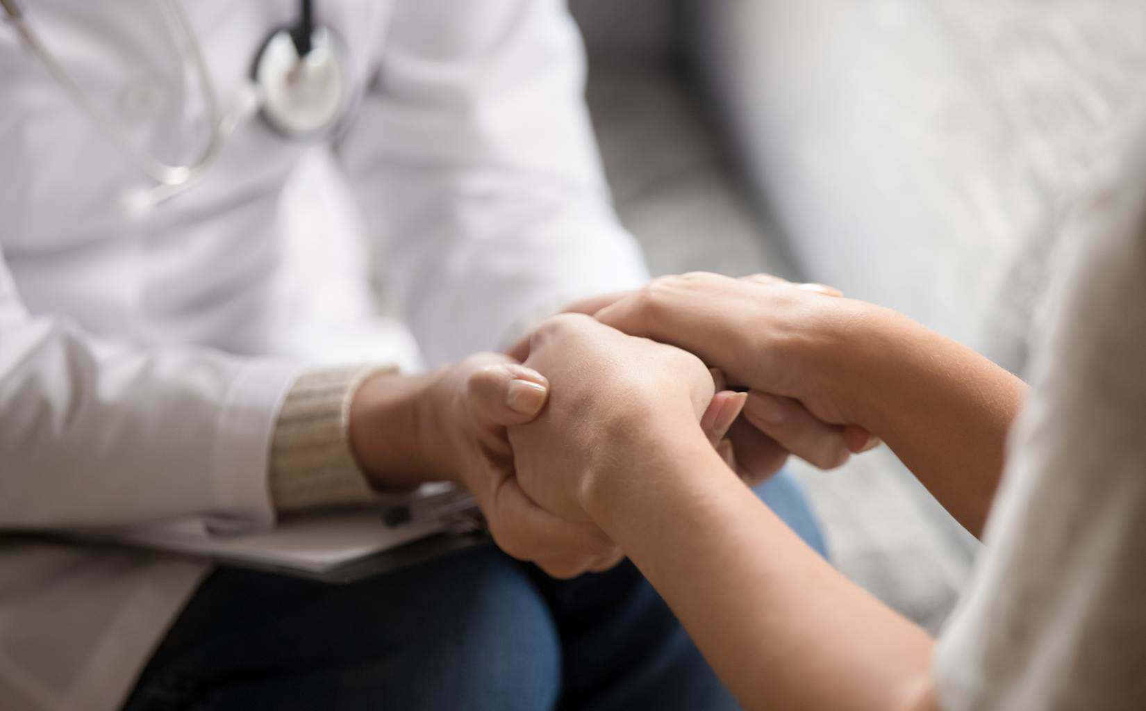 A doctor offering reassurance and support to a patient at a rehab near Troy, Michigan.